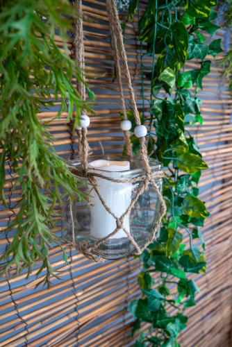 a basket hanging on a wall with a plant at Maio Seaview & Sunset Stay in Kremasti Rhodes in Kremasti