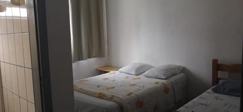 a small bedroom with a bed and a window at Acacia hotel in Laguna