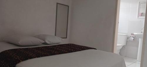 a bed with two pillows on it in a room at Acacia hotel in Laguna