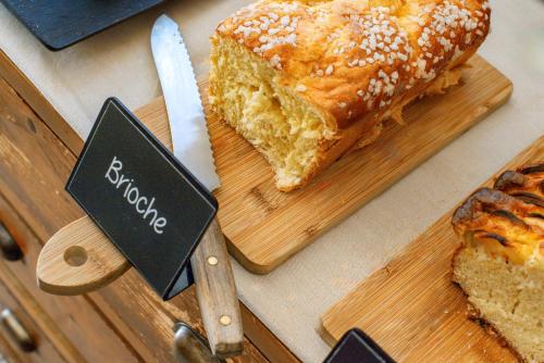 a loaf of bread on a cutting board with a knife at Le Petit Prince in Sainte-Maxime