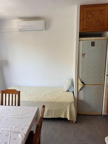 a room with two beds and a refrigerator in it at Edificio Es Pujols 10 ALTA TURISTICA in Es Pujols