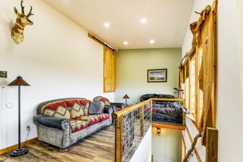 a living room with a couch and a staircase at 5 Mi to Lake Secluded Pinedale Retreat with Sauna! in Pinedale