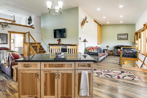 a kitchen with a large island in a living room at 5 Mi to Lake Secluded Pinedale Retreat with Sauna! in Pinedale