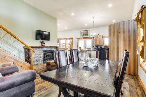 a kitchen and dining room with a table and a fireplace at 5 Mi to Lake Secluded Pinedale Retreat with Sauna! in Pinedale