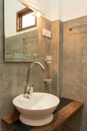 a bathroom with a white sink and a mirror at Ella Jackshade in Ella