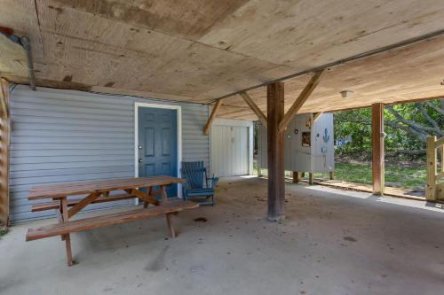a porch with a wooden picnic table in front of a garage at 2010 - Just Ducky in Sanderling