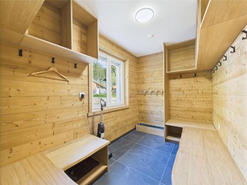 a sauna with wood paneling and a bench at Le Petit Paradis, Spa-Sauna and Gym in Gérardmer