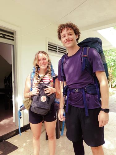a man and a woman standing in front of a building at Susha Happy One First Floor Apartment in Hikkaduwa
