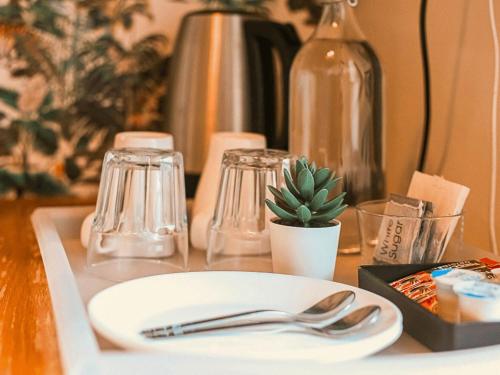 a table with a plate and silverware on it at Gardiner House Hostel in Dublin