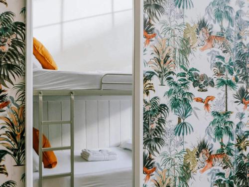 a bedroom with a bunk bed with a tropical wallpaper at Gardiner House Hostel in Dublin