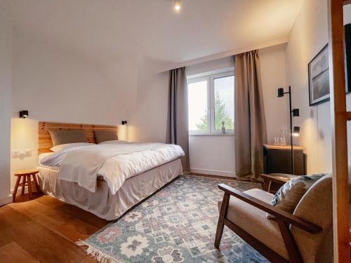 a bedroom with a large bed and a window at Agroturystyka Kaczor nad jeziorem in Męcidół