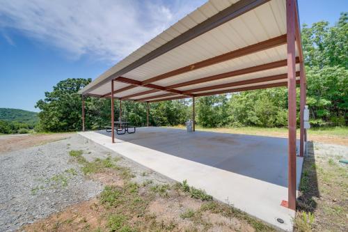 a pavilion with a picnic table in a field at Cabin in Petrified Forest Near Eufala Lake! in Crowder