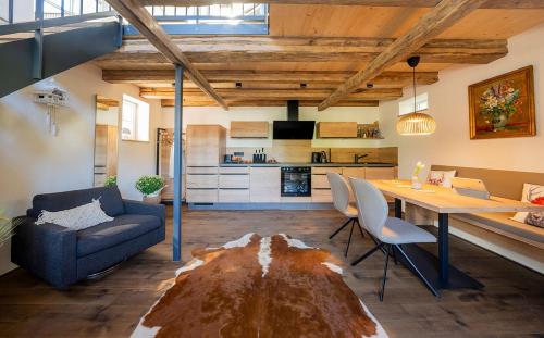a living room with a large wooden table and chairs at Ferienhaus Pflugwirts in Oberkirch