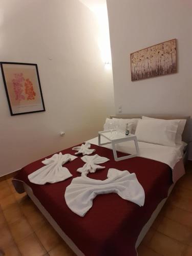 a bedroom with a bed with white clothes on it at Grandma's Pine Apartments in Skála