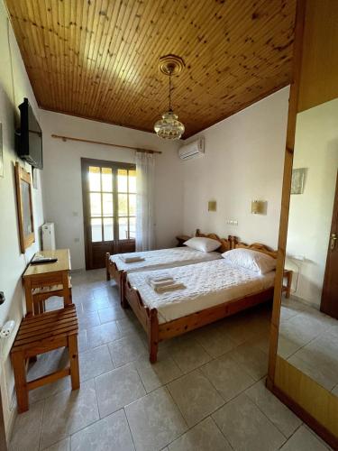 a bedroom with a large bed with a wooden ceiling at Elvira Apartments in Roda