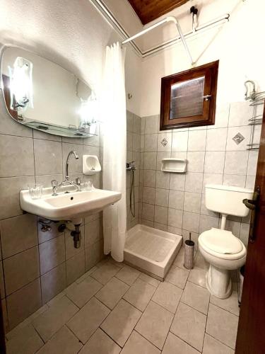 a bathroom with a sink and a toilet at Elvira Apartments in Roda