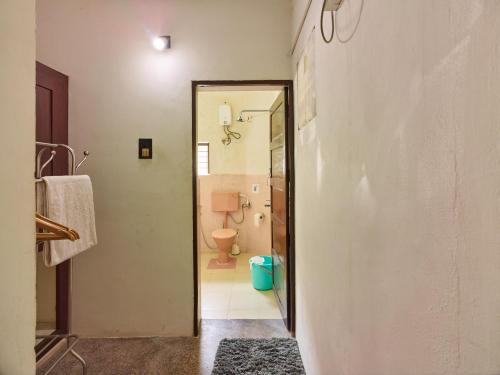 a bathroom with a toilet and a door to at Ushas Homestay in Trivandrum