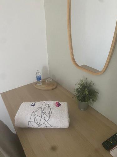 a towel sitting on a desk with a mirror at Rachos in Oujda