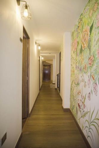 a hallway with a flower mural on the wall at Casa Boutique La Corona Medellin in Envigado