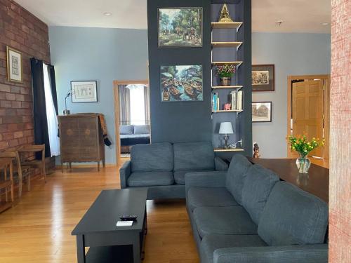a living room with a couch and a table at Suite A 2 BR w/ Bridge St. view in Elkader