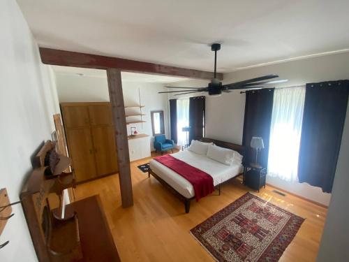 a bedroom with a bed and a ceiling fan at Suite A 2 BR w/ Bridge St. view in Elkader