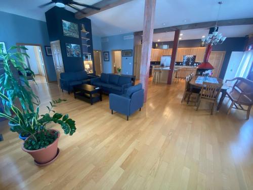 a living room with blue chairs and a table at Suite A 2 BR w/ Bridge St. view in Elkader