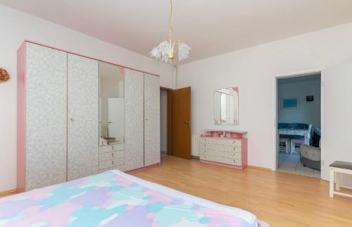 a bedroom with a bed and a dresser and a mirror at Apartments First row in Zavalatica