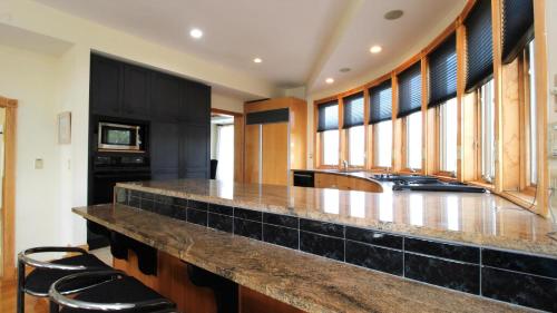 a kitchen with a large island with black counter tops at 1217 Beach -Villa Antinori in Cape May