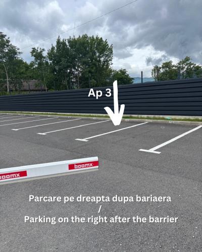 a parking lot with a parking on the right after the barrier at Sfara Residence Apartament 3 in Baia Mare