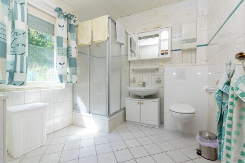 a white bathroom with a sink and a toilet at Apartments First row in Zavalatica
