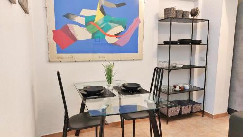 a dining room with a glass table and chairs at Casa Olmedina in Olmedo