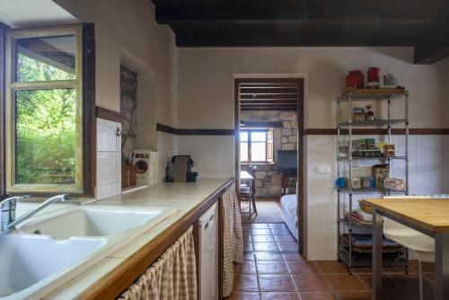a kitchen with a sink and a counter top at Alojamiento Rural Casa Roble -13802 in Güemes