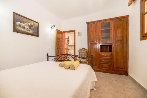 a bedroom with a bed and a wooden door at Arazzo Apartments in Vasilikos