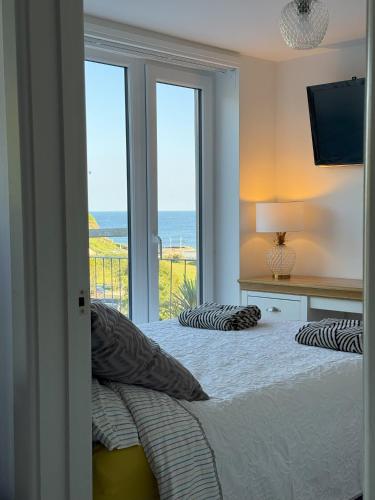 a bedroom with a bed with a view of the ocean at Shorething in Saint Martin