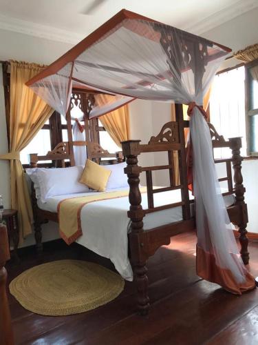 Кровать или кровати в номере Usangi House