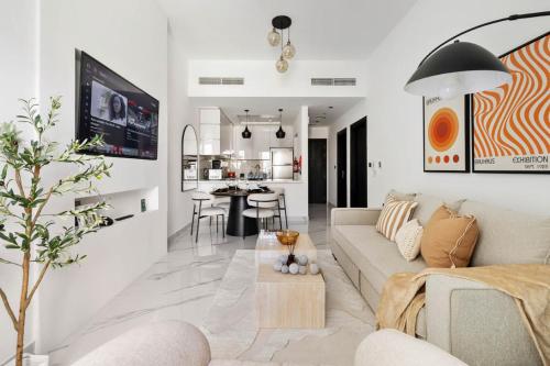 a living room with a couch and a table at New 1BR with Full Balcony Gym Pool and Sauna in Dubai