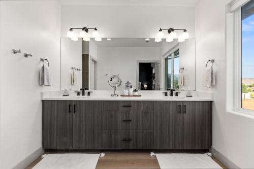 a bathroom with a sink and a mirror at New- Pool, Hot Tub, Nintendo Switch, Pool, Pickleball and Ping Pong Fun in Santa Clara
