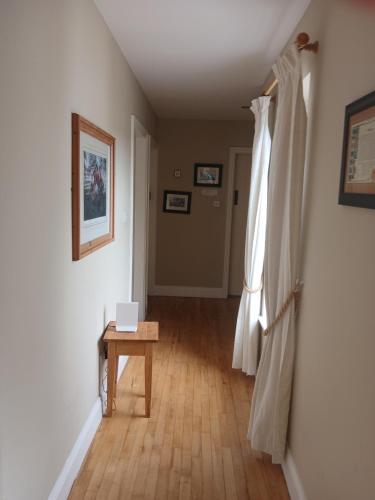 a hallway with a table and a white curtain at Watersedge in Mulranny