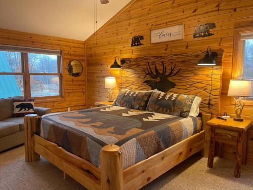 a bedroom with a bed in a log cabin at Perfect Getaway Cabin Near Lake Mille Lacs in Garrison