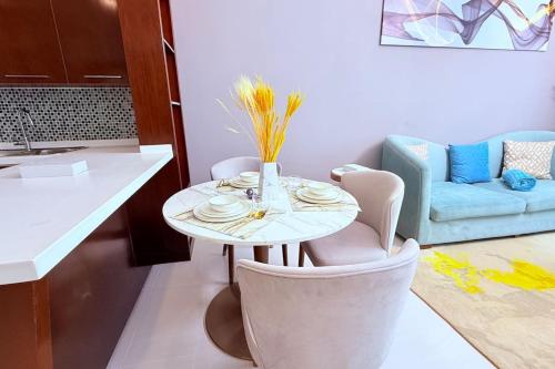 a living room with a table and chairs and a couch at Sea View One Bedroom Balcony in Manama