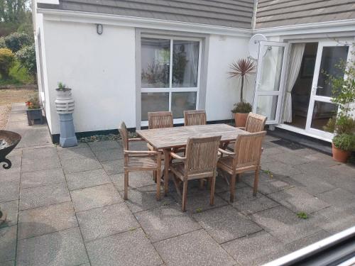 a wooden table and chairs on a patio at Watersedge in Mulranny