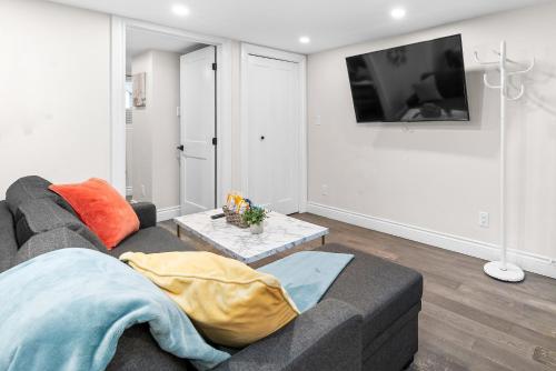 a living room with a couch and a tv at Charming 1BR Flat in Ottawa Historic Lower Town in Ottawa
