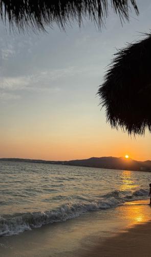 a person walking on the beach at sunset at Condo Mezcales in Mezcales