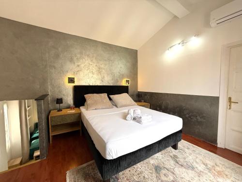 a bedroom with a large white bed in a room at Suite Arnaldo 6 - Sanremo in Sanremo
