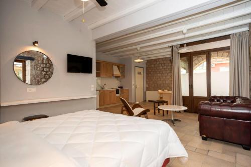a bedroom with a bed and a living room at Myral Guesthouse in Nafplio