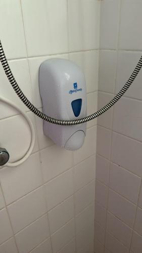 a toilet paper dispenser on a wall in a bathroom at Chez Lilly in Oranjestad