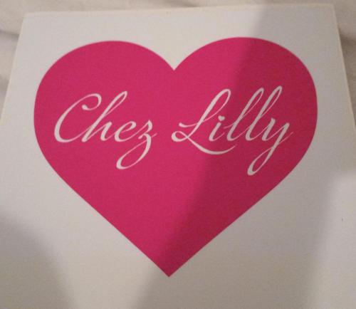 a pink heart with the word dies lilily on it at Chez Lilly in Oranjestad