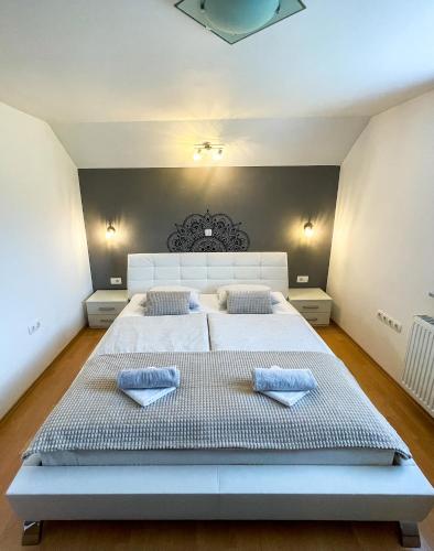 a large bedroom with a large bed with two pillows at Apartment Landscape in Zgornje Gorje