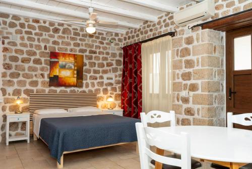 a bedroom with a bed and a table and chairs at Myral Guesthouse in Nafplio