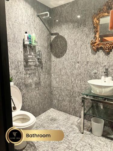 a bathroom with a toilet and a sink at Luxury 4 Bed Room House, Heathrow in Colnbrook